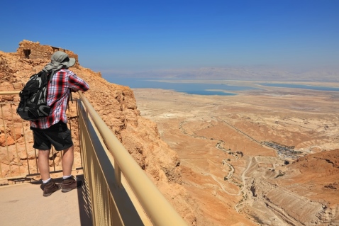 Man taking in the view from the top of Masada